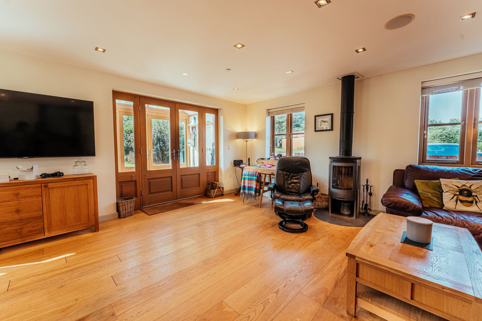 Living room with the wood burning stove and garden doors